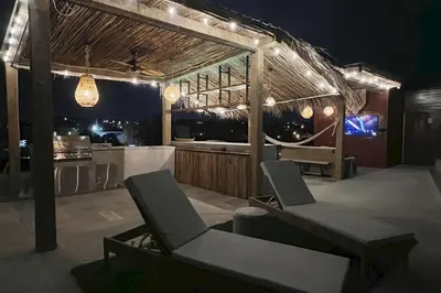 a patio with a table and chairs and a kitchen at Lux Ph & Rooftop Terrace to Relax in Santiago de los Caballeros