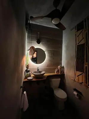 a bathroom with a sink and a toilet and a mirror at Lux Ph & Rooftop Terrace to Relax in Santiago de los Caballeros