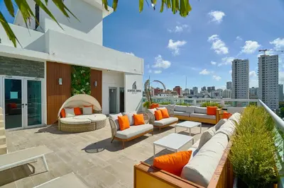 a rooftop patio with couches and a view of the city at Central Suites Tower in Santo Domingo