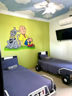 a room with two beds and a cartoon on the wall at Luxury 5 Beds Penthouse - Private Jacuzzi & Karaoke Bar & Free Parking in Santiago de los Caballeros