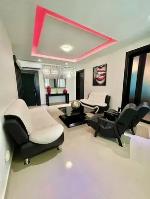 a living room with black and white chairs and a mirror at Luxury 5 Beds Penthouse - Private Jacuzzi & Karaoke Bar & Free Parking in Santiago de los Caballeros