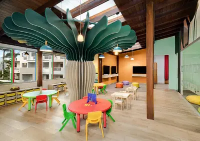 a cafeteria with tables and chairs and a large tree at Sunscape Dominicus La Romana - All Inclusive in Bayahibe