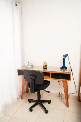 a wooden desk with a chair and a lamp at Habitación privada en Puerto Plata Bayardo in San Felipe de Puerto Plata