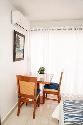 a dining room with a table and two chairs at Habitación privada en Puerto Plata Bayardo in San Felipe de Puerto Plata