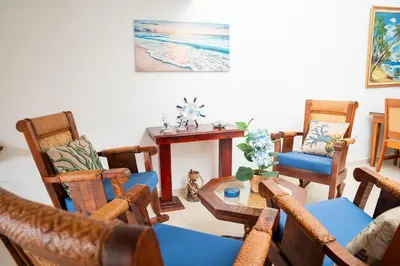 a living room with chairs and a table and a tableablish at Apartamento Los Anturios en Puerto Plata Bayardo in San Felipe de Puerto Plata