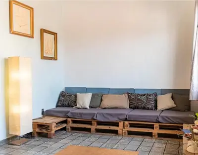 a blue couch sitting in a living room at Room in the Colonial Zone in Santo Domingo