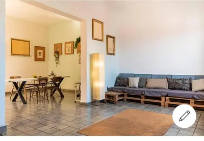 a living room with a blue couch and a table at Room in the Colonial Zone in Santo Domingo