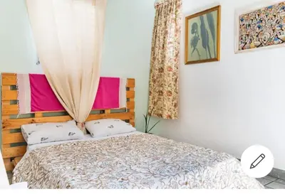 a bedroom with a bed with a wooden headboard at Room in the Colonial Zone in Santo Domingo