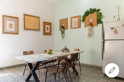 a kitchen with a table with chairs and a refrigerator at Room in the Colonial Zone in Santo Domingo