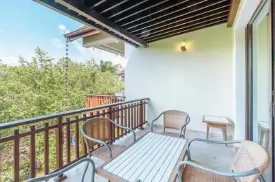 a patio with two chairs and a bench on a balcony at Nearby beach and beach club at Portillo NF in Las Terrenas