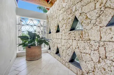 a stone wall in a hallway with a potted plant at Luxurious 8-BR Villa with Ocean View, Jacuzzi, Home Cinema and Resort Access in Casa de Campo in La Romana
