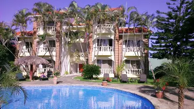 a hotel with a swimming pool in front of a building at Hotel Voramar in Sosúa