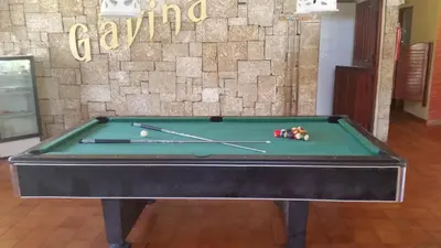 a green pool table with balls on top of it at Hotel Voramar in Sosúa