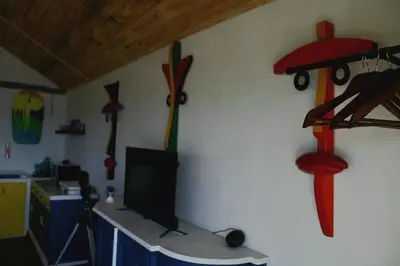 a room with a desk with a television and a wall with decorations at Villas El Bucanero in San Felipe de Puerto Plata
