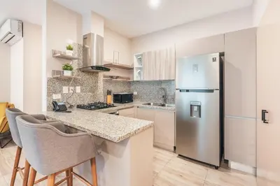 a kitchen with a stainless steel refrigerator and a counter at Breakfast Included at Regatta Living II 203 in Los Prados