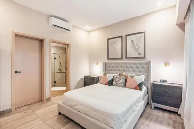 a bedroom with a large white bed with pillows at Breakfast Included at Regatta Living II 203 in Los Prados