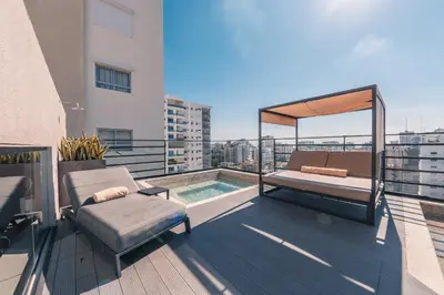 a balcony with a bed and a pool on a building at Breakfast Included at Regatta Living II 203 in Los Prados