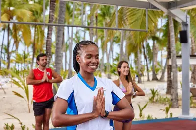 a group of people doing yoga on the beach at Riu Palace Macao - Adults Only - All Inclusive in Punta Cana