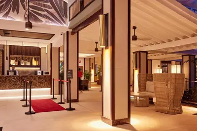 a lobby of a hotel with a red rug at Riu Palace Macao - Adults Only - All Inclusive in Punta Cana