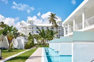 a view of the exterior of a resort with a swimming pool at Riu Palace Macao - Adults Only - All Inclusive in Punta Cana