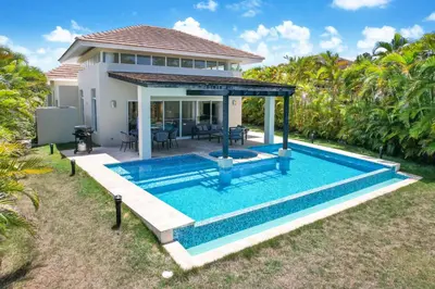 a swimming pool in front of a villa at Stunning 3-Bedroom Villa with Pool, Jacuzzi and Maid near Bavaro Beach in Punta Cana