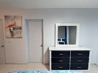 a room with a dresser with a mirror and a dresser with a dress at Apartamento a 5 min de la playa in San Felipe de Puerto Plata