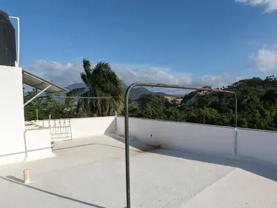 a metal rail on a balcony with a view of a mountain at Apartamento a 5 min de la playa in San Felipe de Puerto Plata
