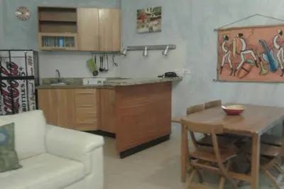 a kitchen with a table and a couch and a table and chairs at Appartamenti in Cadaques Caribe in Bayahibe
