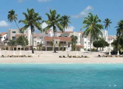 a view of a beach with palm trees and buildings at Appartamenti in Cadaques Caribe in Bayahibe