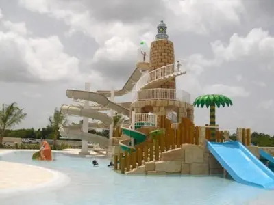 a water park with a water slide in the water at Appartamenti in Cadaques Caribe in Bayahibe