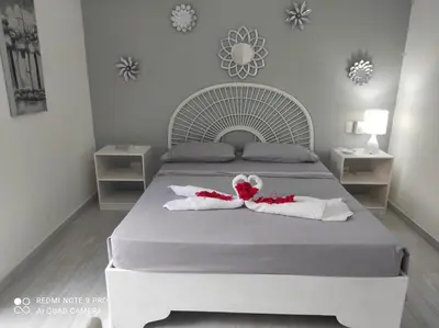 a bedroom with a bed with two towels on it at Villa Preciosa in Bayahibe