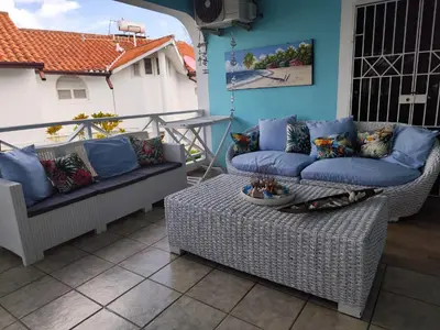 a patio with two couches and a table on a balcony at Villa Preciosa in Bayahibe