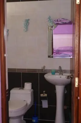a bathroom with a toilet and a sink and a mirror at Casa Vacanze Dume in Bayahibe