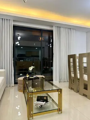 a living room with a glass table and a couch at Premium space in Santiago- 5 Min Away from airport in Santiago de los Caballeros