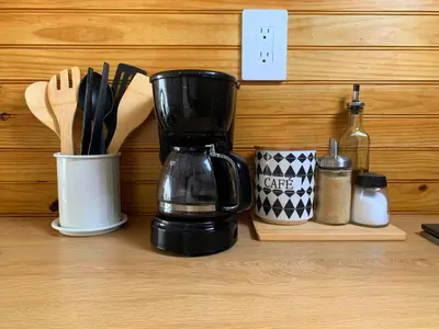 a coffee maker sitting on a counter with utensils at Domescape Glamping in El Cedro