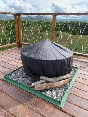 a black cover sitting on a wooden deck at Domescape Glamping in El Cedro