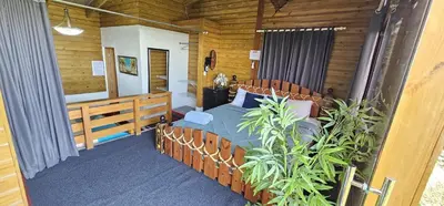 a bedroom with a bed and some plants in it at Villa Leon in Jarabacoa