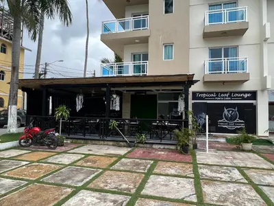 a restaurant with a motorcycle parked in front of a building at Casa Mulata Paseo del Mar Pool & Playa in Punta Cana