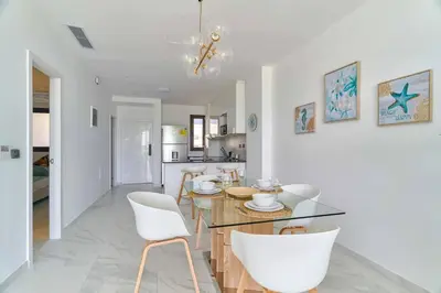 a dining room and kitchen with a table and chairs at Luxury Apartment at Cana Rock Star Punta Cana DR in Punta Cana