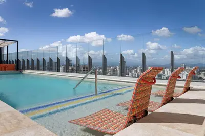 a swimming pool on the top of a building at Aloft Santo Domingo Piantini in Santo Domingo