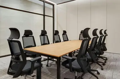 a conference room with a wooden table and black chairs at Aloft Santo Domingo Piantini in Santo Domingo