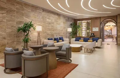 a lobby with couches and chairs and tables at Santo Domingo Marriott Hotel Piantini in Santo Domingo