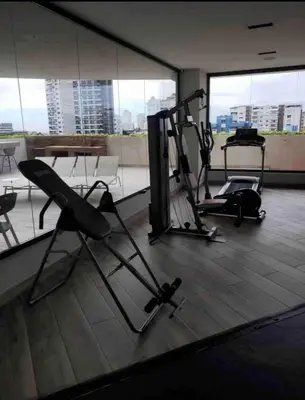 a gym with two tread machines in a building at VIP DELUXE AND TOWER J7_POOL_GYM_SAUNE_WIFE in Santo Domingo