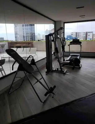 a gym with two tread machines in a building at VIP DELUXE SUITE AND TOWER E11 POOL_GYM_SAUNE_WIFE in Santo Domingo