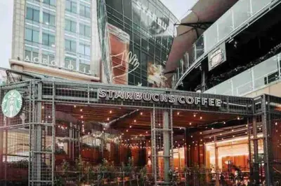 a store front with a sign that reads starbucks coffee at VIP DELUXE SUITE AND TOWER E11 POOL_GYM_SAUNE_WIFE in Santo Domingo