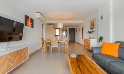 a living room with a couch and a table at The Garden | Beauty NEW 2 BR With Pool View in Punta Cana