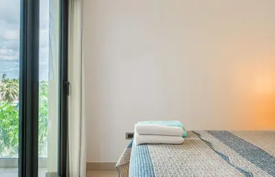 a bedroom with a bed with towels on it at The Garden | Beauty NEW 2 BR With Pool View in Punta Cana