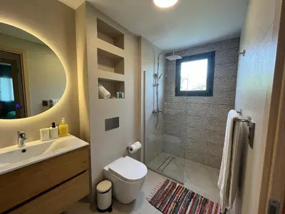 a bathroom with a shower and a toilet and a sink at The Garden | Beauty NEW 2 BR With Pool View in Punta Cana