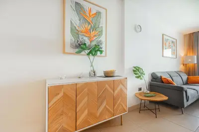 a living room with a couch and a cabinet at The Garden | Beauty NEW 2 BR With Pool View in Punta Cana