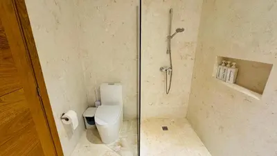 a bathroom with a toilet and a glass shower at 3 Bedroom Beach Villa With Parking in Las Terrenas